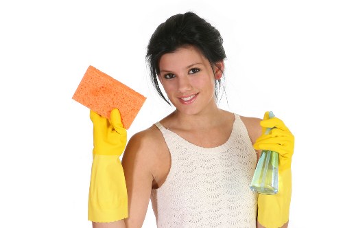 Local cleaner preparing a built-in oven for move out inspection